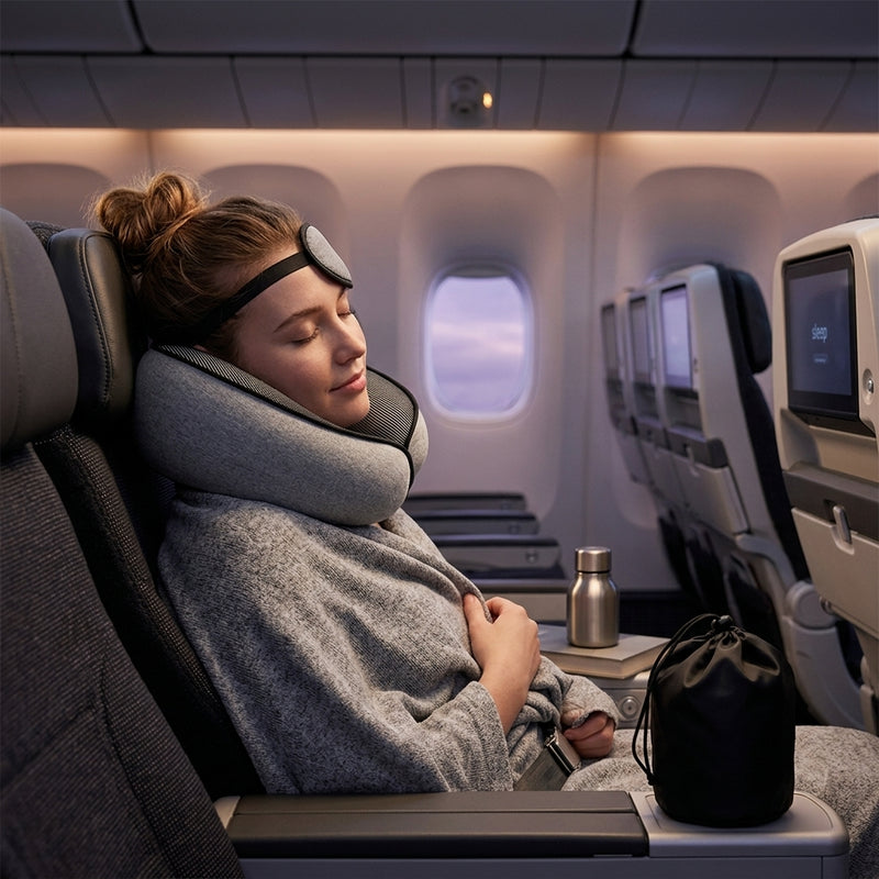Person sleeping comfortably on a plane with a travel pillow